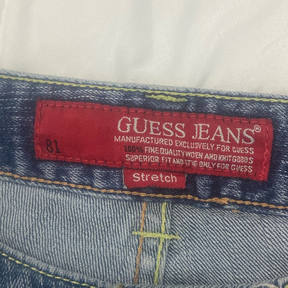 Guess Jeans, size 29. Dark blue, lightly distressed with gold gems.